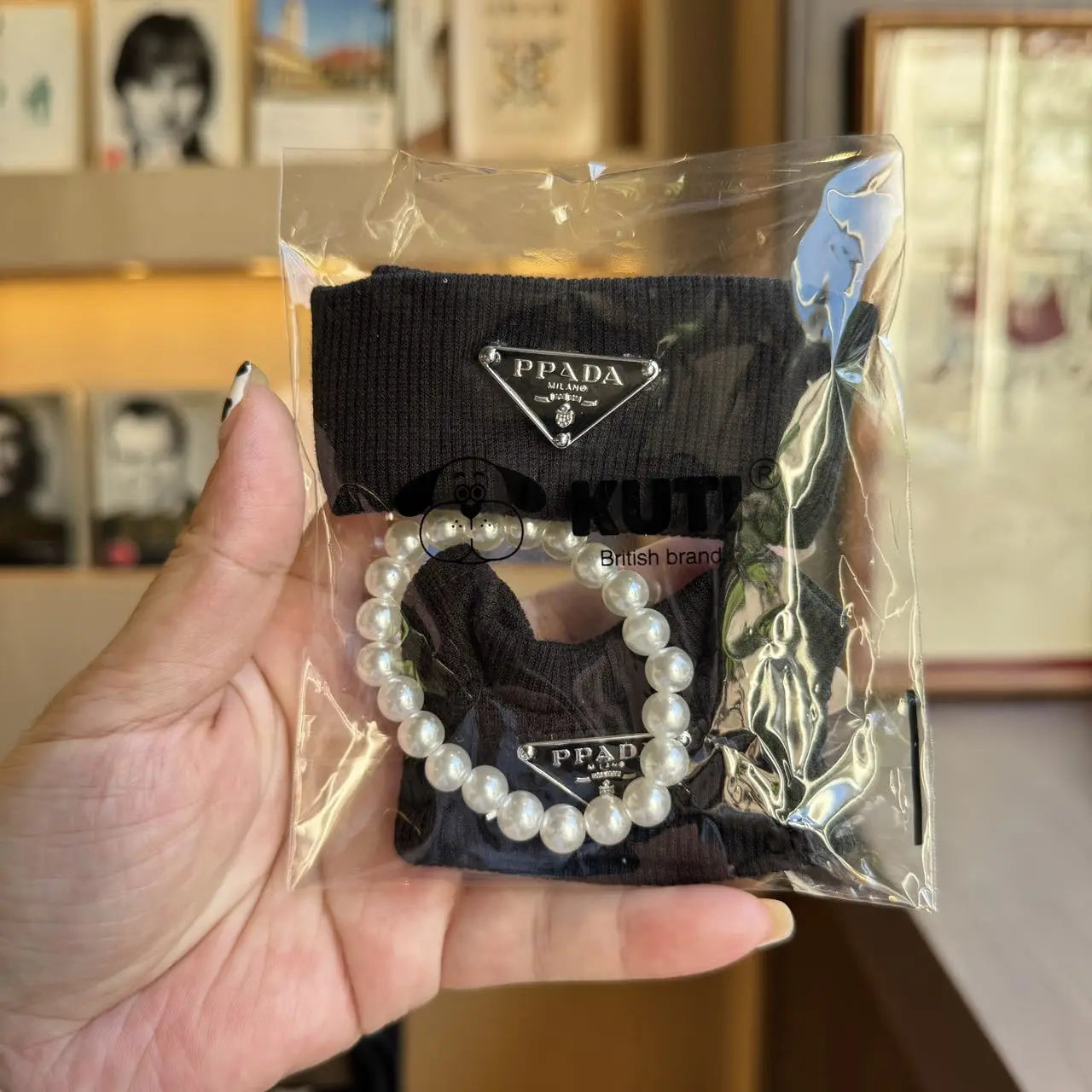 Prada sweater outfit with pearl necklace