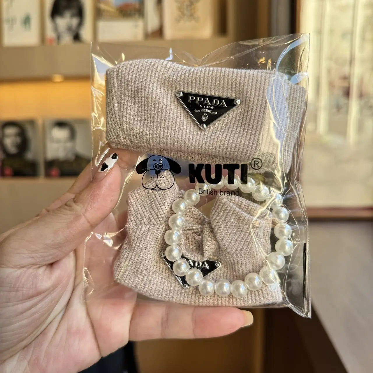 Prada sweater outfit with pearl necklace