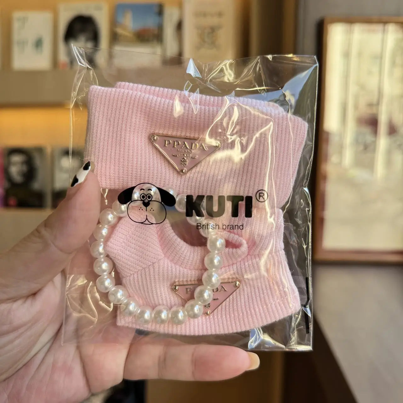 Prada sweater outfit with pearl necklace