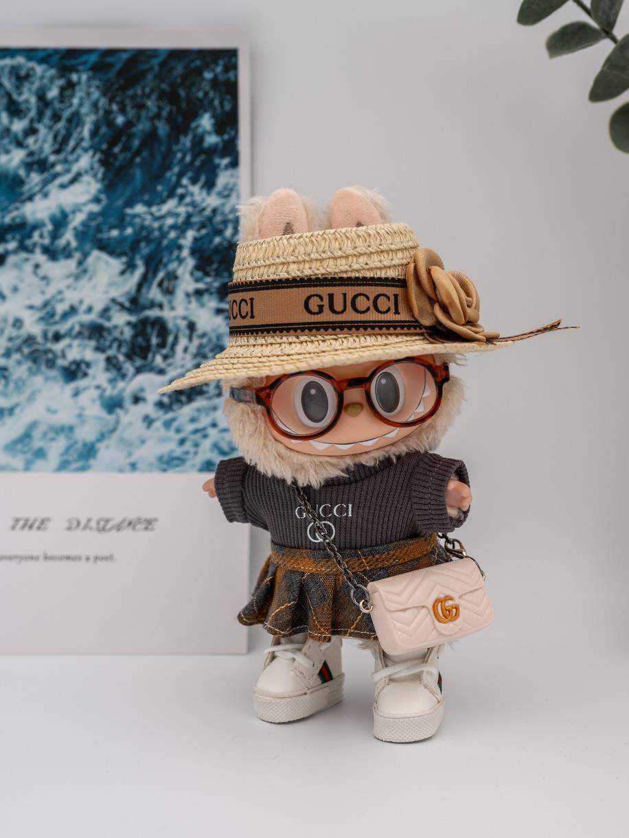 Gucci gray sweater and plaid skirt ensemble